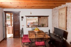 a dining room with a wooden table and chairs at Canary House With Heated Pool in Tuineje
