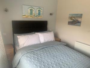 a bedroom with a bed and two pictures on the wall at Seabrook Lodge in Newquay