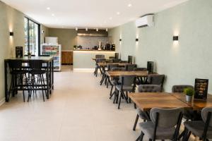 a dining room with wooden tables and chairs at New Green Airport Hotel & Restaurant in Arnavutköy