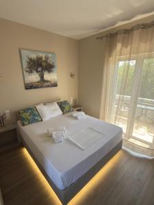 a bedroom with a large bed with a window at Diana's Houses in Gythio