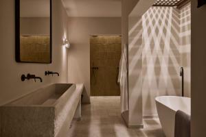 a bathroom with a large tub and a shower at Ostraco Houses in Pachaina