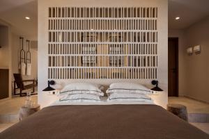 a bedroom with a large bed with two pillows at Ostraco Houses in Pachaina