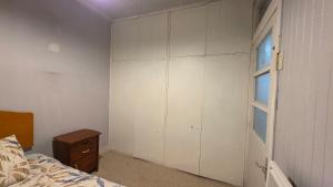 a bedroom with a closet and a bed and a window at Alojamiento Centro de Punta Arenas in Punta Arenas