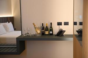 a table with bottles of wine and glasses on it at Vivere Hotel in Catania