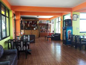 a living room with a couch and a table with chairs at Hotel Greenland in Nagarkot