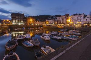 a group of boats docked in a harbor at night at Admiral's Quarters in Dartmouth +4 photos