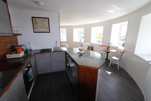 a kitchen with a counter and a table in a room at Admiral's Quarters in Dartmouth