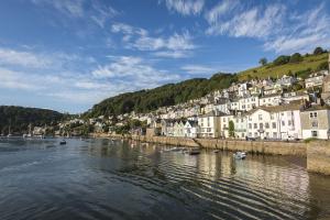 a town on a river with boats in the water at Admiral's Quarters in Dartmouth