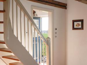 a staircase in a home with a white stair case at Ferienwohnung Blücherkate I - Boldevitzer Rügenkaten in Parchtitz