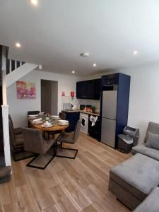 a living room with a table and a kitchen at 14 Eyre Square Lane in Galway