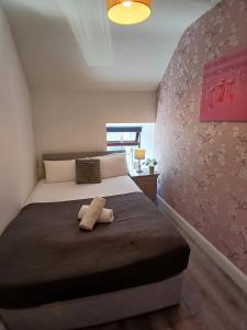 a stuffed animal sitting on a bed in a bedroom at 14 Eyre Square Lane in Galway +12 photos