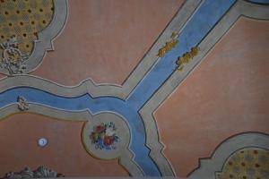 a ceiling in a building with a painting on it at Vivere Hotel in Catania