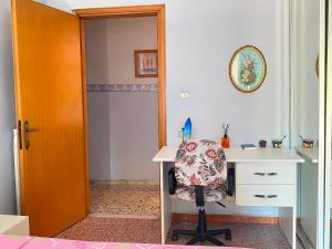 a room with a desk and a chair next to a door at Appartamento Nonna Ida in Montesarchio