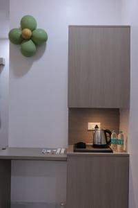 a kitchen with a stove with a pot on it at Hotel vs rooms in Ankleshwar