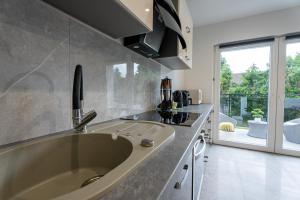 a kitchen with a large tub in the middle at Bieszczady Hill - Dolna in Czarna +28 photos