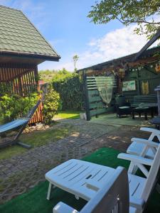 a patio with a bench and a gazebo at Pod Szklaną Wydmą - 2 min pieszo do plaży in Chłopy