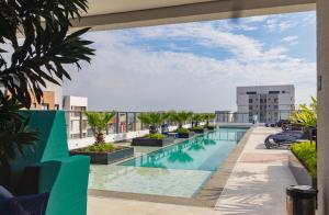 a view of a swimming pool on top of a building at Prime Exalt Ibirapuera in São Paulo