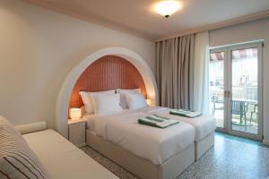 a hotel room with a bed and a balcony at Villa Coo Boutique Hotel - Adults Only in Kos +97 photos