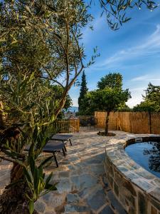 a patio with two benches and a pool at Trigono Suites - Primavera 
