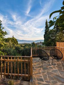 two chairs sitting on a patio with a fence at Trigono Suites - Primavera 