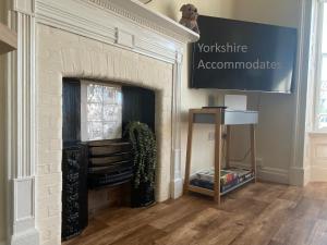 a white brick fireplace with a sign on it at Spa View Apartments in Ripon