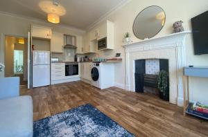 a kitchen with a fireplace and a mirror on the wall at Spa View Apartments in Ripon