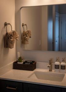 a bathroom with a sink and a mirror at The Sand and Sage Suite in Page