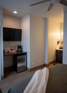 a hotel room with a bed and a flat screen tv at The Sand and Sage Suite in Page