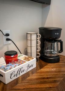 a coffee bar with a coffee maker and a box on a counter at The Sand and Sage Suite in Page