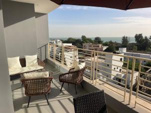 a balcony with chairs and a view of the city at Rubis2 appart C2 in Ngaparou