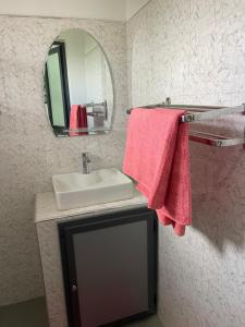 a bathroom with a sink and a mirror at Rubis2 appart C2 in Ngaparou +7 photos