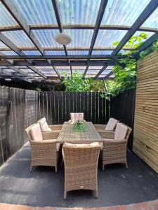 a patio with a table and chairs under a pergola at 7 Eyre Square Lane in Galway