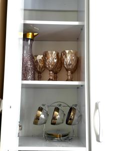a shelf with glasses and a vase in a refrigerator at Квартира 2х ком на Амангельды 1 in Balqash