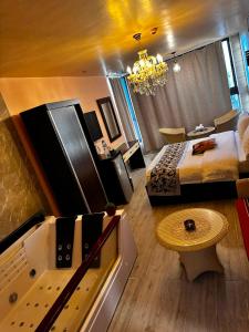 a bedroom with a king sized bed and a chandelier at AL NAHAR AL KHALEd in Aqaba