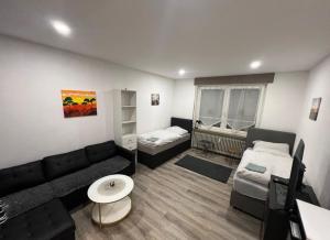 a living room with a couch and a bed at Unterkunft Gjino Wirges in Wirges