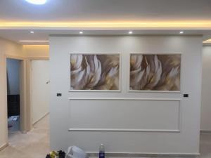 a fireplace in a room with a white wall at Your sweet house in Minshāt Şabrī