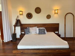a bedroom with a bed with two pillows on it at Verdana House in Kiwengwa +110 photos