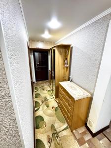 a hallway with a sink and a floor with shoes at Квартира 2х ком на Амангельды 1 in Balqash +24 photos