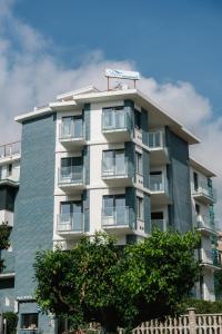 a tall building with balconies on the side of it at Residence La Scogliera in Alassio
