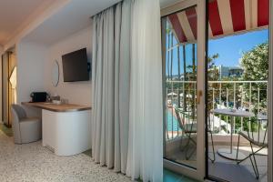 a room with a view of a balcony with a table at Villa Coo Boutique Hotel - Adults Only in Kos