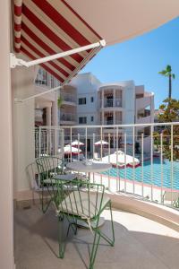 a table and chairs on a balcony with a pool at Villa Coo Boutique Hotel - Adults Only in Kos