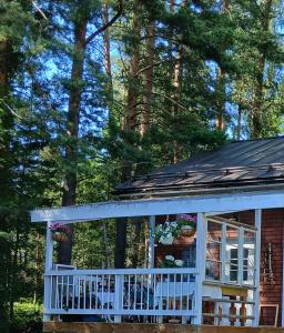 a small house with a porch and trees at Suvela in Muurame +3 photos