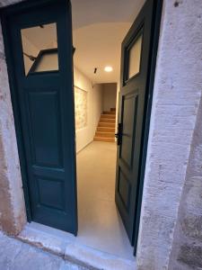 an open door into a hallway with a staircase at Lausa Dubrovnik Rooms in Dubrovnik +50 photos