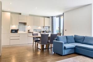 a living room with a blue couch and a table at Cotswolds Apartment 1, sleeps 4 in Chipping Norton