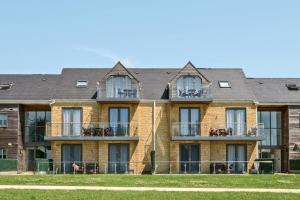 a large brick building with balconies on it at Cotswolds Apartment 1, sleeps 4 in Chipping Norton