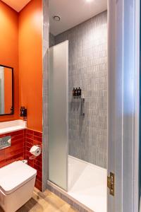 a bathroom with a shower with a toilet and a sink at Ansty Hall in Coventry