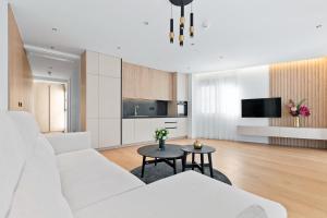 a living room with a white couch and a table at VELIERO Residence by Bracera in Lugovi