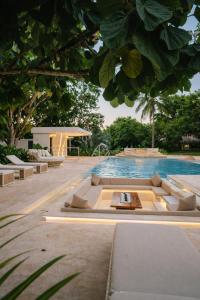 a pool with lounge chairs and a table next to it at Finca Hotel Dubai in San Jerónimo