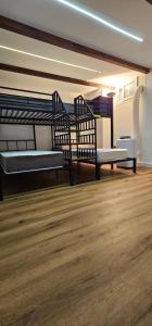 a room with two beds and a wooden floor at B&B Gianni in Capodrise