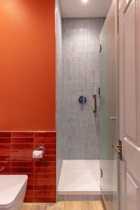 a bathroom with a shower with a toilet and a sink at Ansty Hall in Coventry